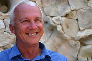 Martin Meader stands outside against a feature wall