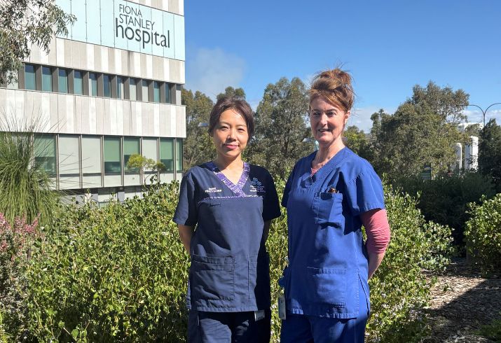 Nurse Practitioners Xiyuan Li and Jen Turner standing together outside, with a Fiona Stanley Hospital sign in the background.