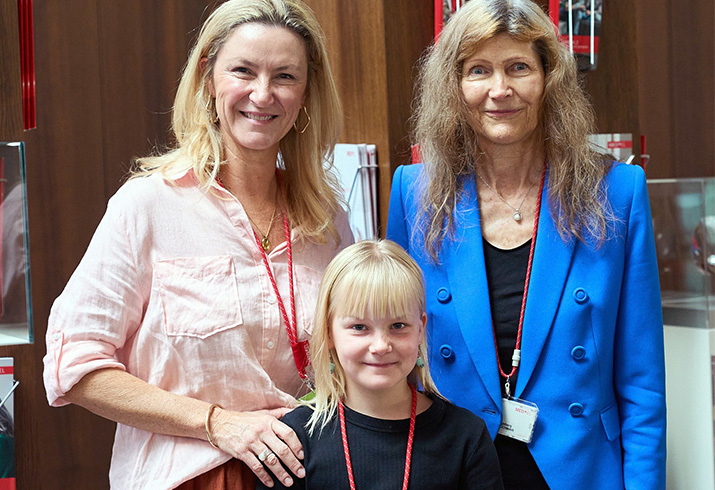 Genevieve Hodgson (back left) stands with her arm on the shoulder of her young daughter Asha. Standing beside them is MED-EL Implant Systems CEO, Dr Ingeborg Hochmair.