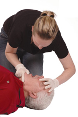 Woman tilting man&rsquo;s head back using a finger and thumb grip on his chin (chin lift).