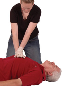 Woman performing chest compressions on a man&rsquo;s chest.
